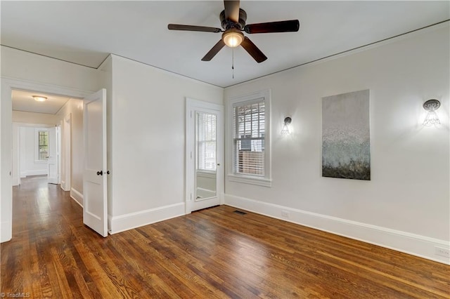 spare room featuring dark hardwood / wood-style flooring and ceiling fan