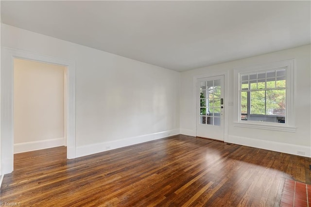 spare room with dark hardwood / wood-style flooring