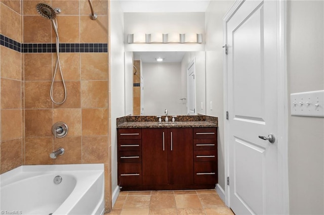 bathroom with tile floors, large vanity, and tiled shower / bath