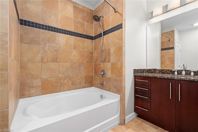 bathroom featuring tiled shower / bath, vanity, and tile floors