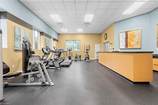 gym with a paneled ceiling