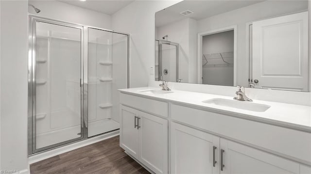 1529 String Dr, Winston-Salem, NC 27107 - full bathroom featuring a stall shower, double vanity, wood finished floors, and a walk in closet