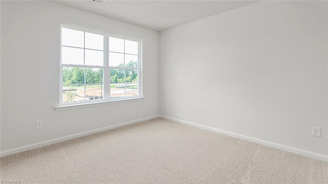 1529 String Dr, Winston-Salem, NC 27107 - unfurnished room featuring baseboards and light carpet