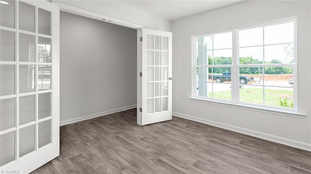 1529 String Dr, Winston-Salem, NC 27107 - empty room with wood finished floors, baseboards, and french doors