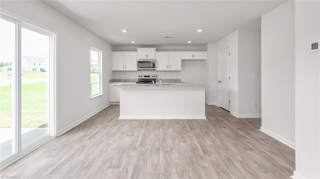 1529 String Dr, Winston-Salem, NC 27107 - kitchen with appliances with stainless steel finishes, baseboards, light wood-style flooring, white cabinets, and recessed lighting