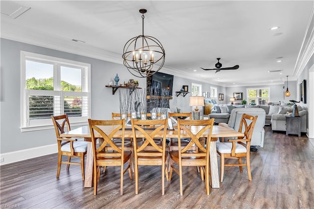 dining space featuring baseboards, wood finished floors, and ornamental molding