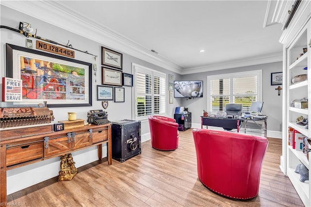 office area featuring visible vents, wood finished floors, baseboards, and ornamental molding