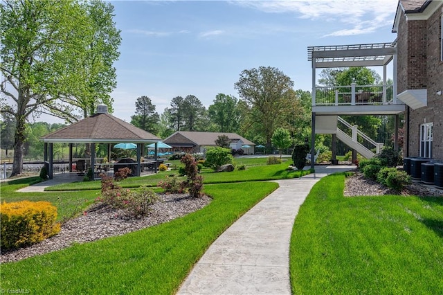 surrounding community with a gazebo, stairway, a lawn, and a pergola