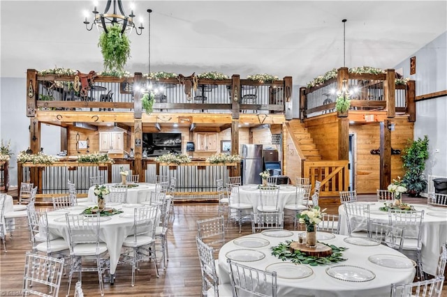 dining space with a chandelier and wood finished floors