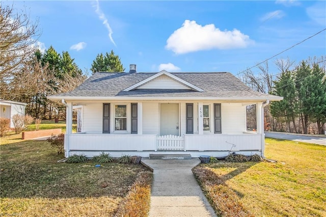 bungalow-style home with covered porch and a front yard