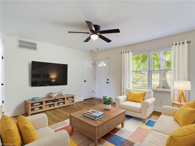 living room featuring ceiling fan and light hardwood / wood-style flooring