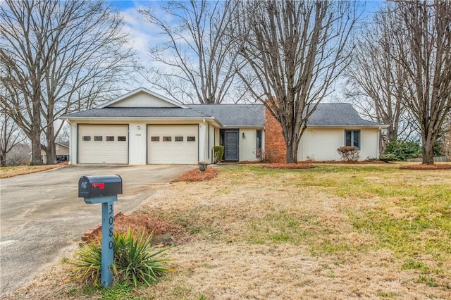 single story home featuring a garage and a front yard