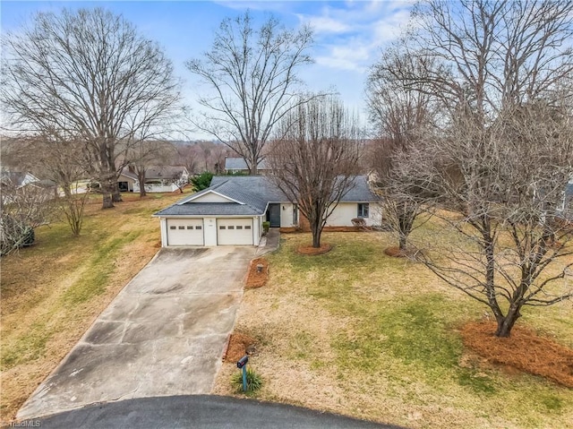 single story home with a garage and a front lawn