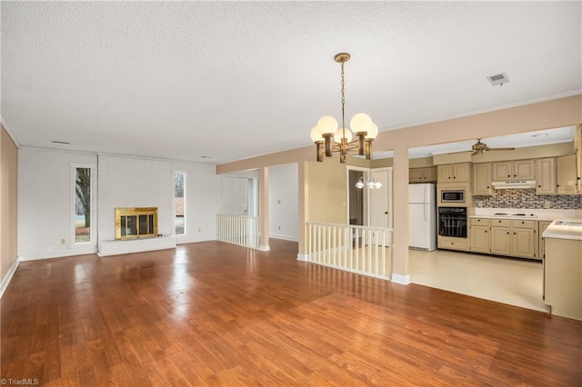 unfurnished living room featuring a brick fireplace, light hardwood / wood-style flooring, and ornamental molding