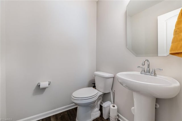 bathroom with sink, toilet, and hardwood / wood-style floors