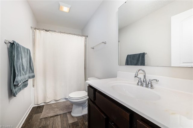 bathroom featuring wood-type flooring, vanity, and toilet