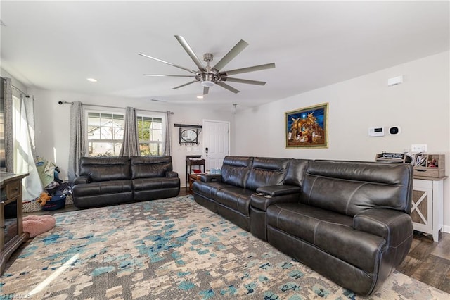 living room featuring dark hardwood / wood-style floors and ceiling fan