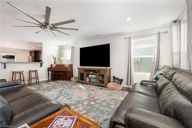 living room with hardwood / wood-style flooring and ceiling fan