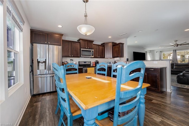 dining space featuring dark wood-type flooring and ceiling fan