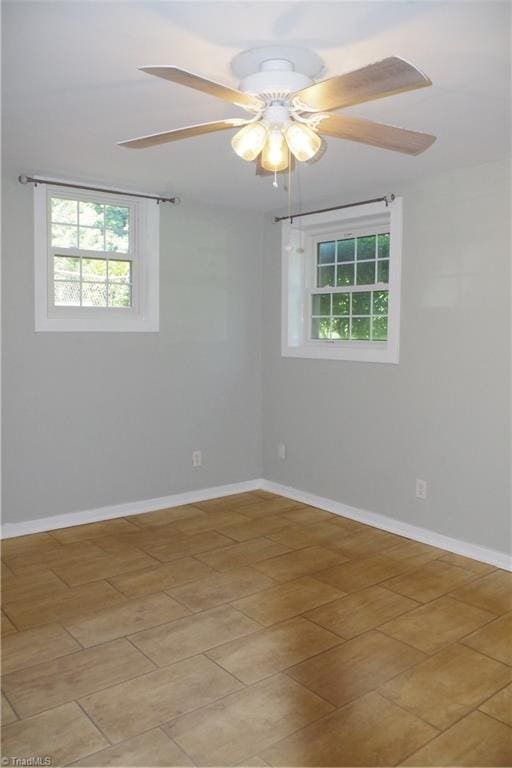 unfurnished room featuring ceiling fan and light tile patterned floors