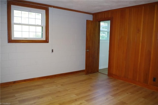 empty room featuring crown molding and light hardwood / wood-style floors