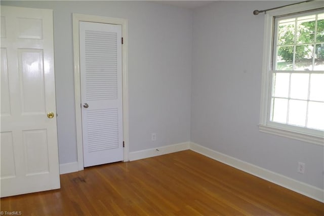 unfurnished bedroom with hardwood / wood-style floors