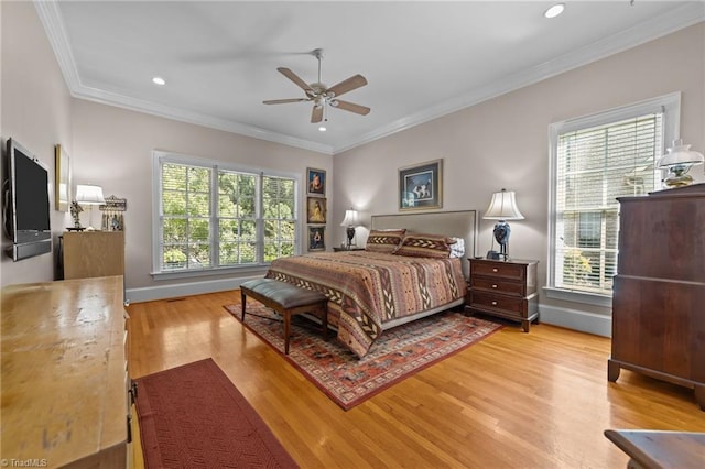 bedroom featuring crown molding, ceiling fan, and light hardwood / wood-style flooring