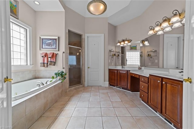 bathroom featuring tile patterned flooring, vanity, and shower with separate bathtub