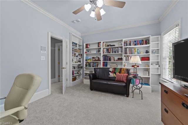 sitting room featuring ceiling fan, light colored carpet, and ornamental molding