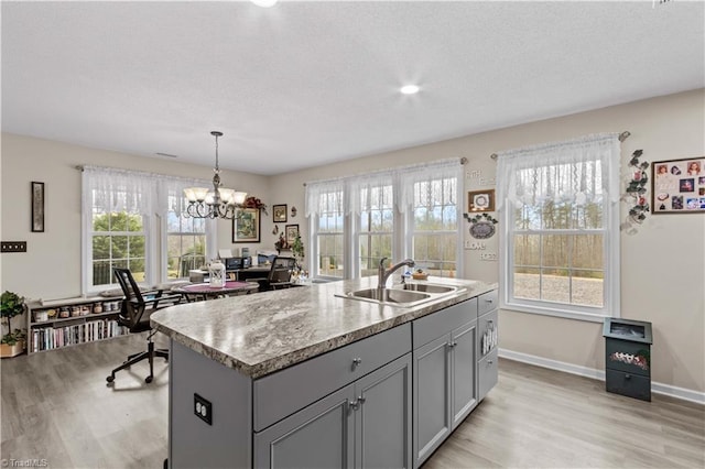 1595 Cheatham Ford Rd, Hiddenite, NC 28636 - kitchen with gray cabinetry, light wood-style flooring, light countertops, and a sink