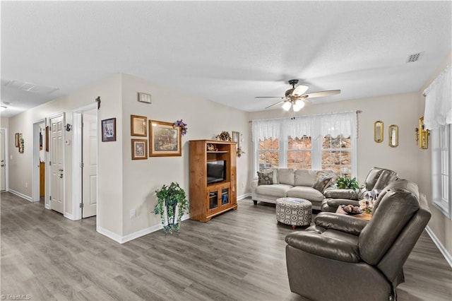 1595 Cheatham Ford Rd, Hiddenite, NC 28636 - living room with a textured ceiling, wood finished floors, a ceiling fan, and visible vents