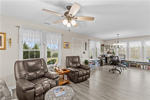 1595 Cheatham Ford Rd, Hiddenite, NC 28636 - living room with visible vents, a textured ceiling, wood finished floors, and ceiling fan with notable chandelier