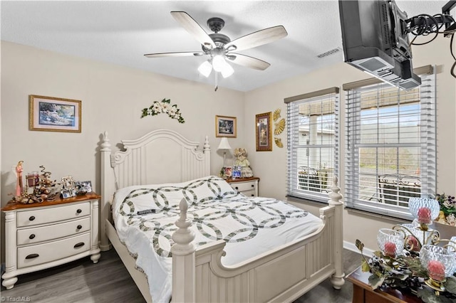 1595 Cheatham Ford Rd, Hiddenite, NC 28636 - bedroom with visible vents, dark wood-style flooring, baseboards, and ceiling fan