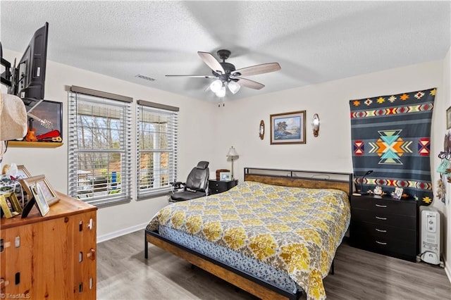 1595 Cheatham Ford Rd, Hiddenite, NC 28636 - bedroom featuring visible vents, baseboards, wood finished floors, and a textured ceiling