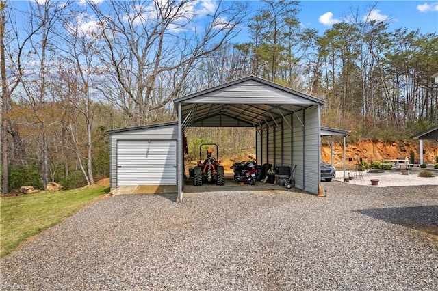 1595 Cheatham Ford Rd, Hiddenite, NC 28636 - view of outdoor structure featuring a carport, driveway, and an outdoor structure
