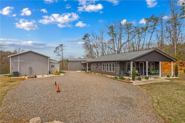 1595 Cheatham Ford Rd, Hiddenite, NC 28636 - ranch-style house featuring an outbuilding, a patio, a front yard, gravel driveway, and a shingled roof