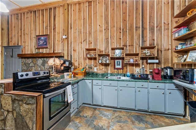 1595 Cheatham Ford Rd, Hiddenite, NC 28636 - kitchen featuring open shelves, appliances with stainless steel finishes, wood walls, a sink, and dark countertops