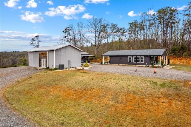 1595 Cheatham Ford Rd, Hiddenite, NC 28636 - view of front of house featuring an outbuilding, central AC, an outdoor structure, a front yard, and gravel driveway