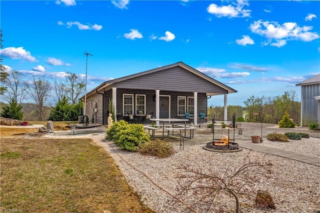 1595 Cheatham Ford Rd, Hiddenite, NC 28636 - view of front facade with a patio area, a front yard, an outdoor fire pit, and covered porch