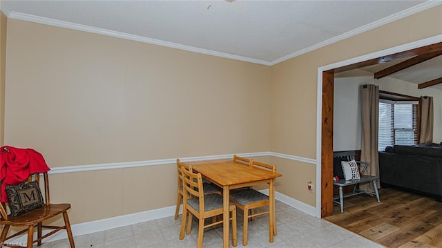 dining space with beamed ceiling, light hardwood / wood-style floors, and ornamental molding