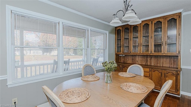 dining room with dark hardwood / wood-style floors and ornamental molding