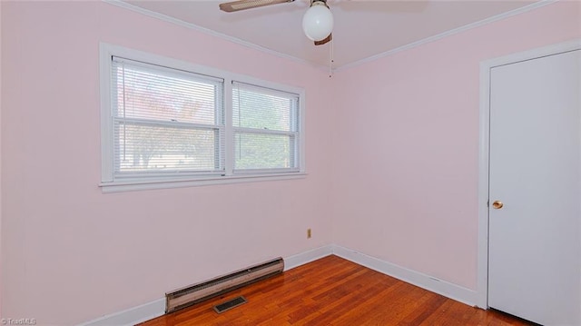 unfurnished room with hardwood / wood-style floors, crown molding, ceiling fan, and a baseboard heating unit