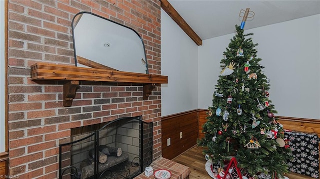 interior details featuring a fireplace, hardwood / wood-style flooring, and beamed ceiling