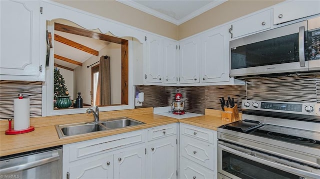 kitchen featuring decorative backsplash, sink, white cabinetry, and stainless steel appliances