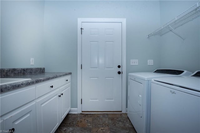 laundry room with sink, independent washer and dryer, and cabinets