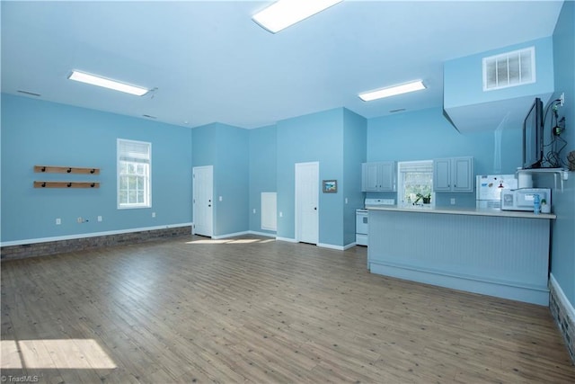 unfurnished living room featuring hardwood / wood-style flooring