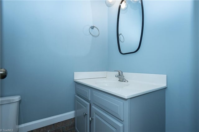 bathroom featuring toilet and vanity