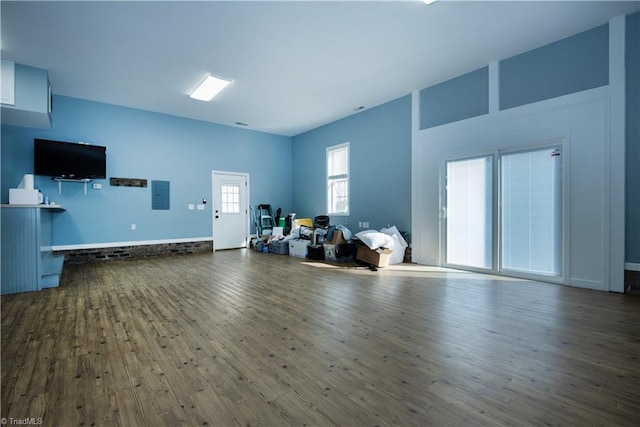 unfurnished living room featuring hardwood / wood-style flooring and electric panel