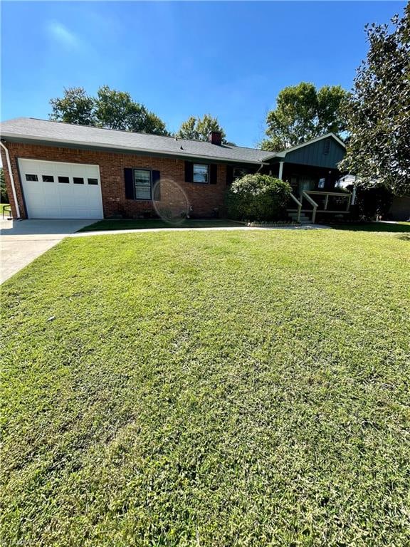 single story home featuring a garage and a front yard