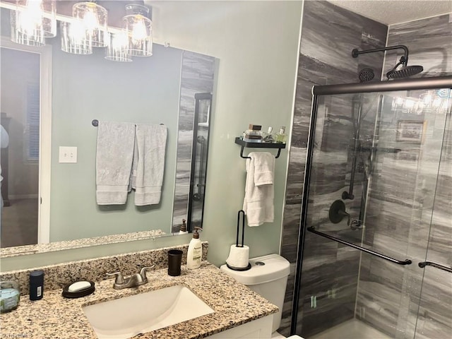 bathroom with walk in shower, vanity, and toilet